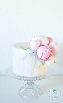 Grey marble cake with pink sugar peonies on top