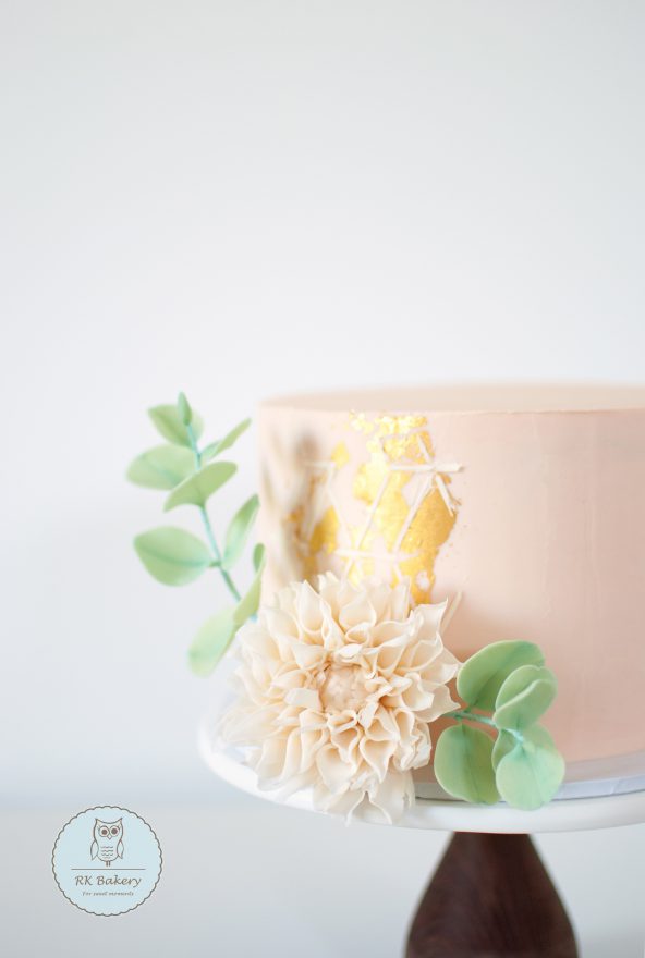 Pastel cake with sugar dahlia and eucalyptus decorations