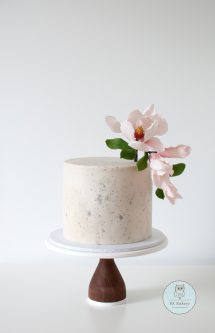 Textured ivory cake with sugar magnolias on top